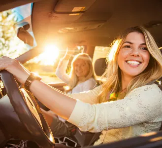 Happy customer driving a new car